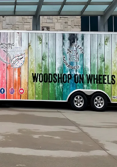 The Woodshop on Wheels trailer, painted in rainbow wood planks